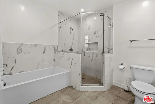 an empty room with wooden floor and mirror