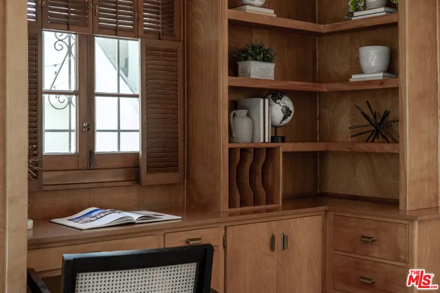 a view of a house with a small yard plants and large tree