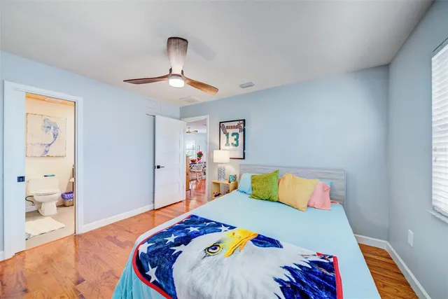 a bedroom with a bed and a lamp on dresser