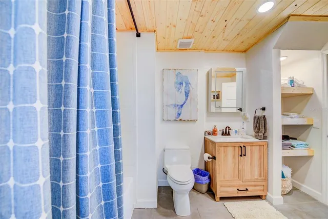 a bathroom with a sink toilet vanity and shower