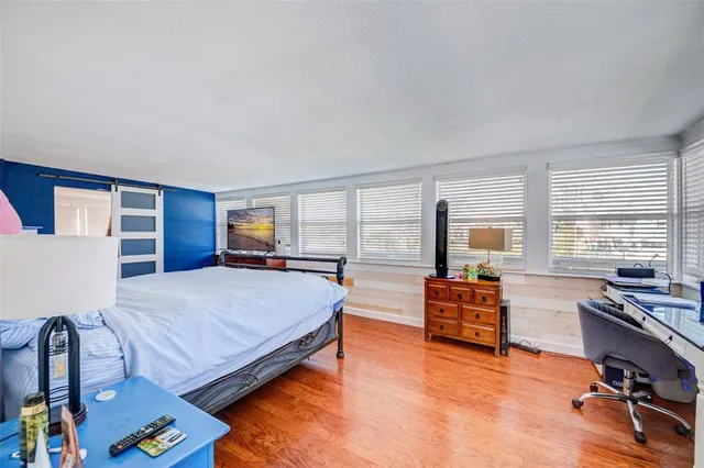 a bed sitting in a bedroom next to a window