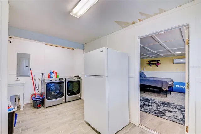 a kitchen that has a sink cabinets and wooden floor
