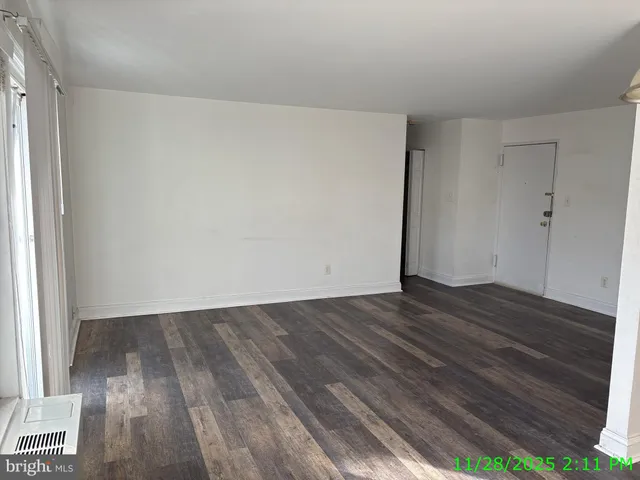 a view of an empty room and wooden floor