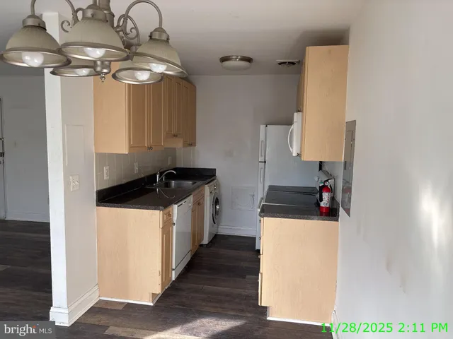 a kitchen with a sink a stove and cabinets