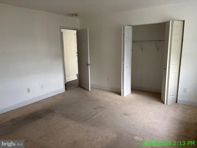 an empty room with closet area