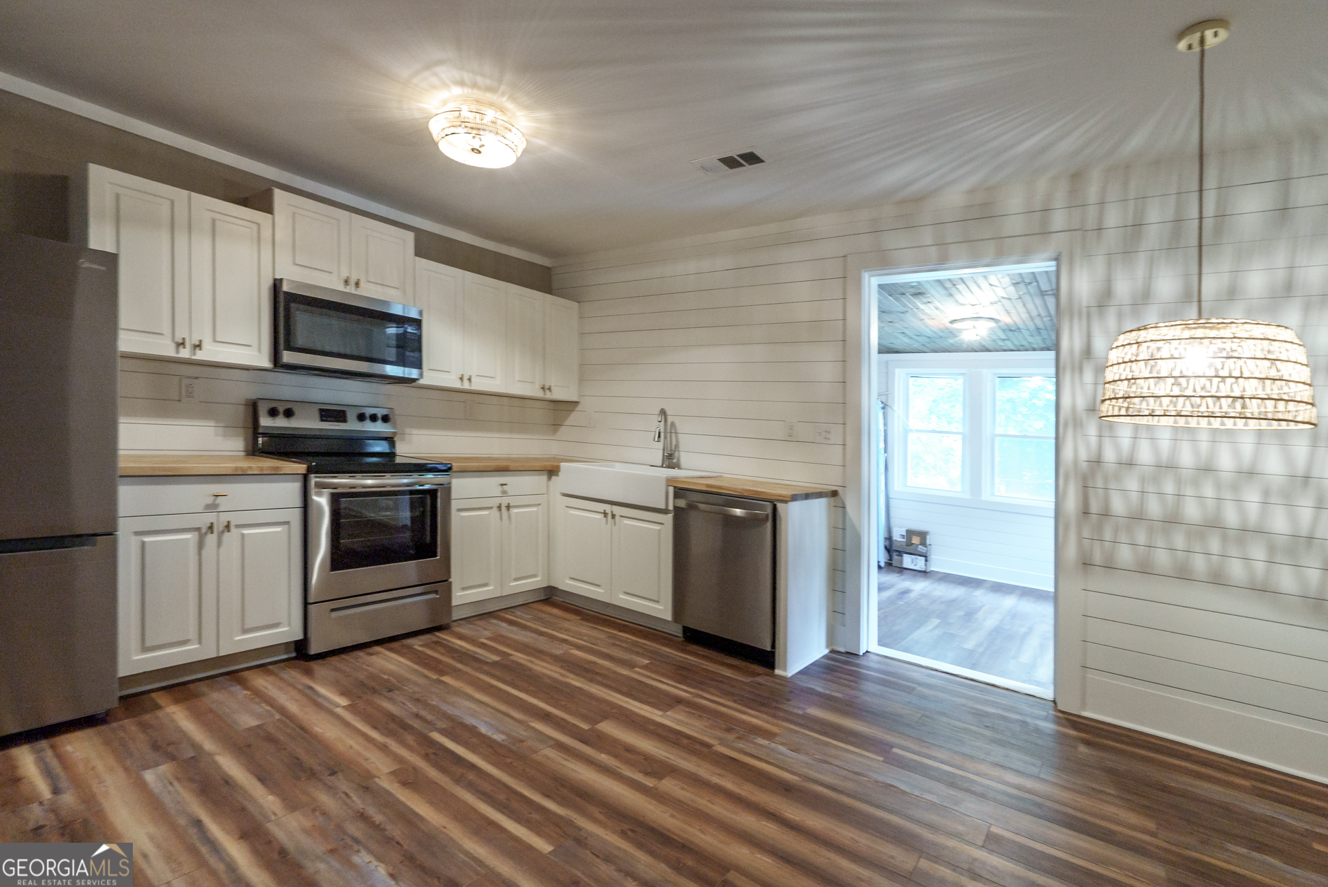 175 East Main Street, Unit B Rutledge, GA 30663 - Photo 14 of 28 a kitchen with granite countertop a sink and steel appliances