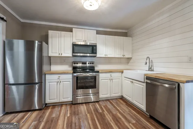 a kitchen with stainless steel appliances granite countertop a stove and cabinets