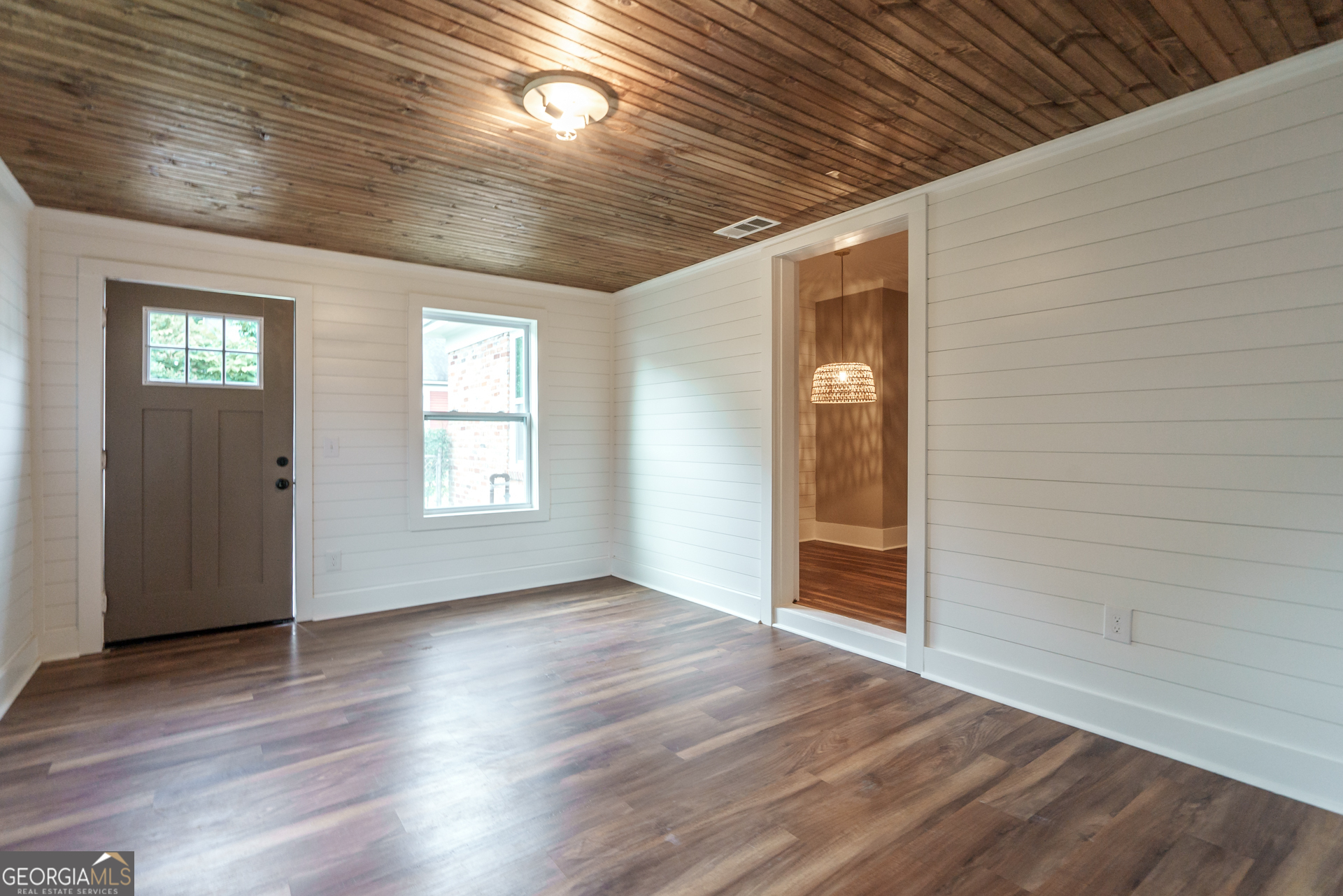 175 East Main Street, Unit B Rutledge, GA 30663 - Photo 20 of 28 a view of an empty room with wooden floor and a window