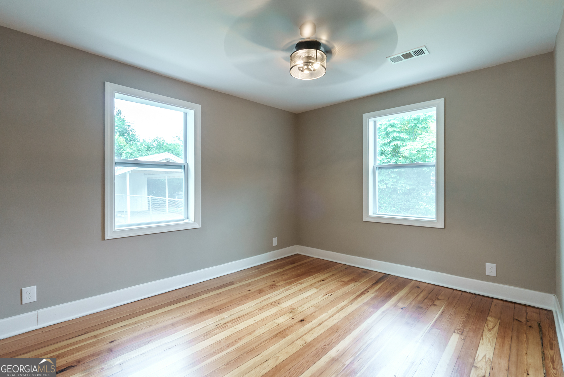 175 East Main Street, Unit B Rutledge, GA 30663 - Photo 26 of 28 a view of empty room with wooden floor and fan