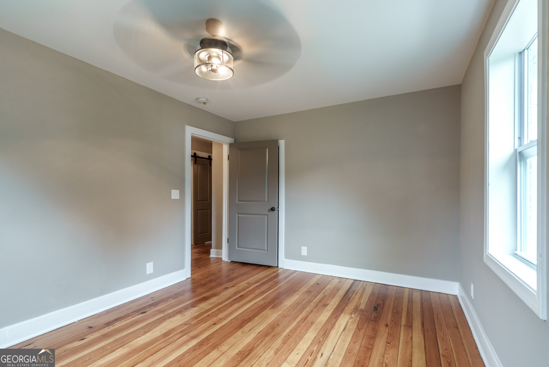 175 East Main Street, Unit B Rutledge, GA 30663 - Photo 27 of 28 a view of an empty room with wooden floor and a window