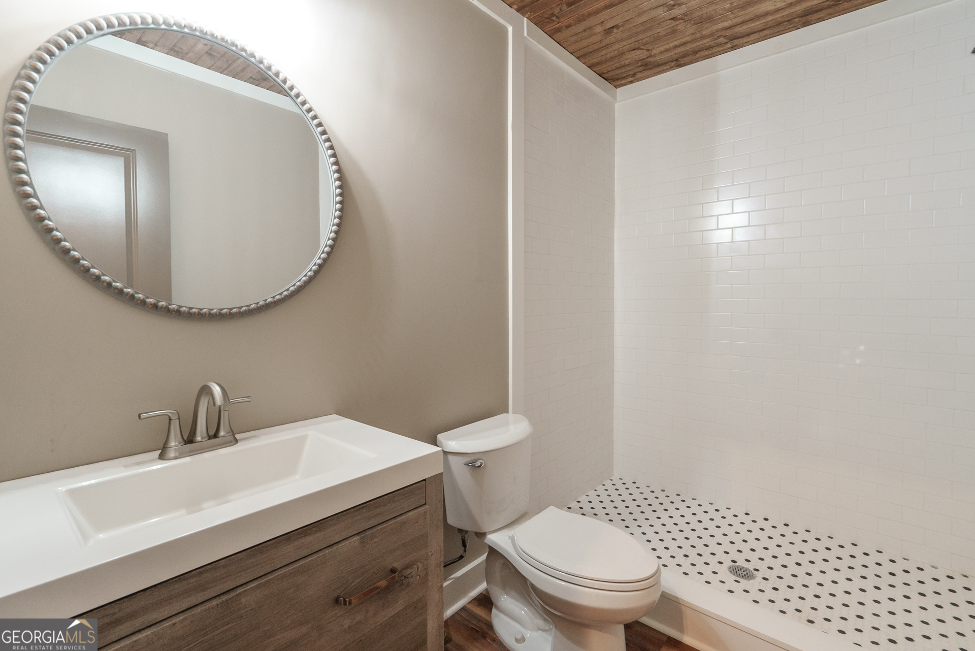 175 East Main Street, Unit B Rutledge, GA 30663 - Photo 28 of 28 a bathroom with a sink a toilet and a mirror