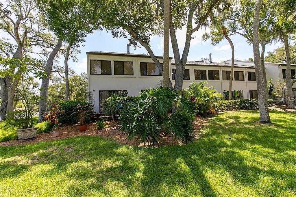 11450 Harbor Way, Unit 5002 Largo, FL 33774 - Photo 3 of 25 a view of a house with a yard and sitting area