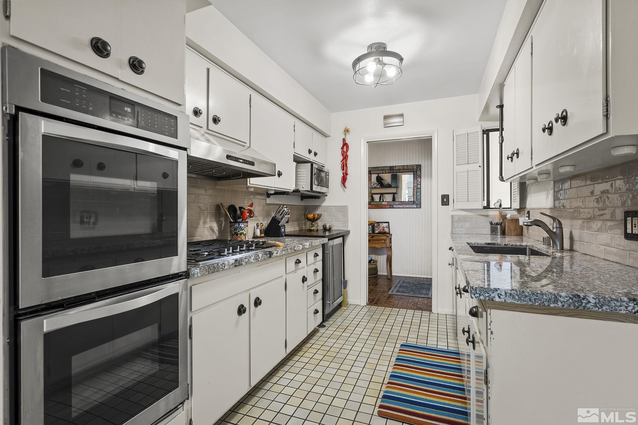 1985 Windsor Way Reno, NV 89503 - Photo 5 of 16 a kitchen with stainless steel appliances granite countertop a sink and a stove
