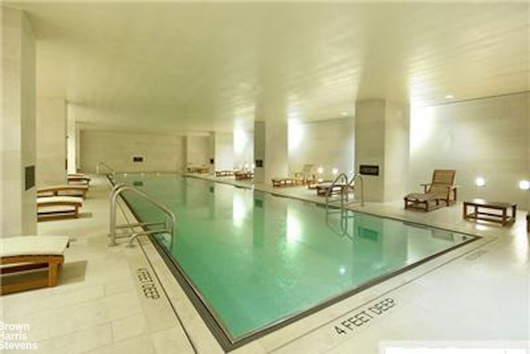 20 Pine Street, Unit 2706 Manhattan, NY 10005 - Photo 10 of 18 a large pool table with chairs