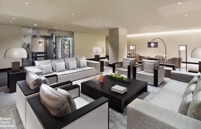 a living room with furniture and a lamp