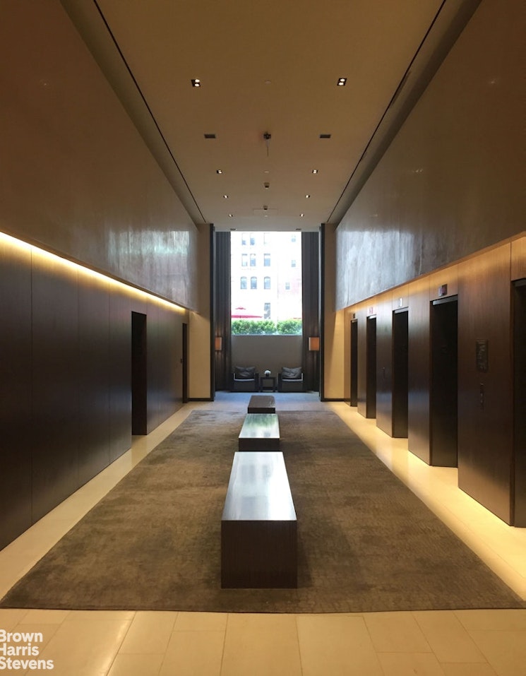 20 Pine Street, Unit 2706 Manhattan, NY 10005 - Photo 15 of 18 a view of hallway with stairs