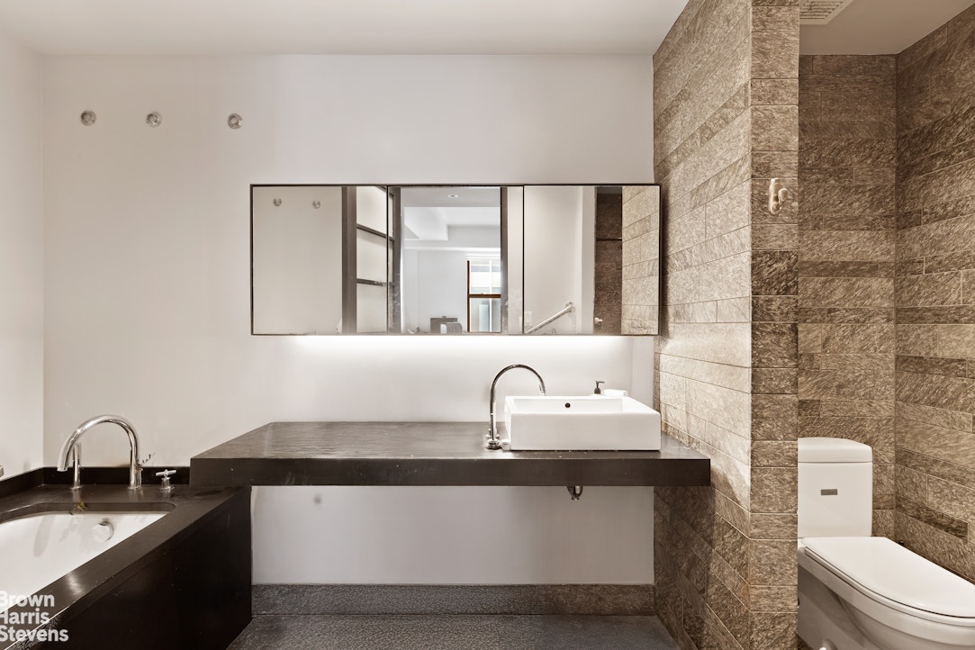 20 Pine Street, Unit 2706 Manhattan, NY 10005 - Photo 5 of 18 a bathroom with a sink and a toilet