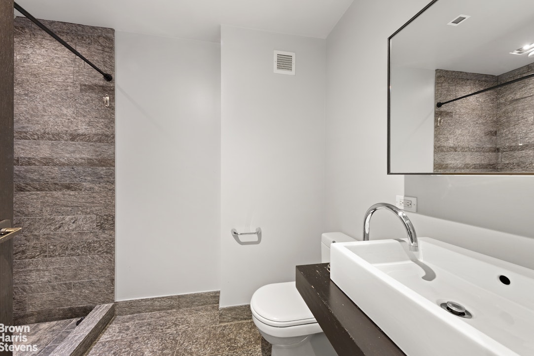 20 Pine Street, Unit 2706 Manhattan, NY 10005 - Photo 6 of 18 a bathroom with a sink and a toilet