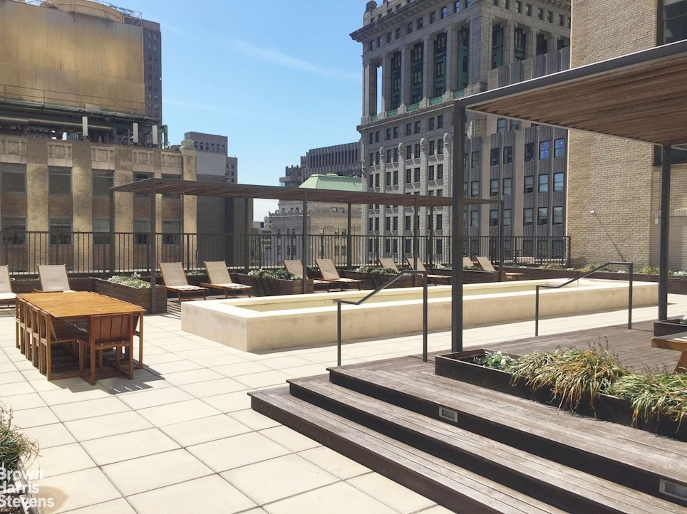 20 Pine Street, Unit 2706 Manhattan, NY 10005 - Photo 8 of 18 a swimming pool with outdoor seating