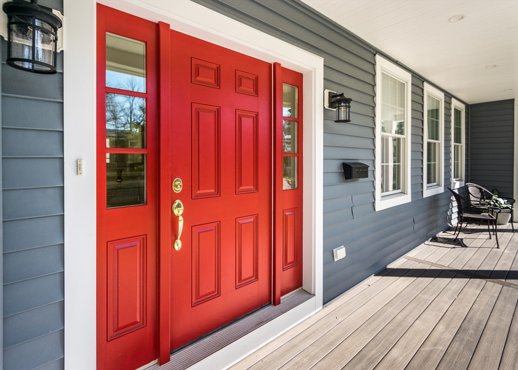 a view of a balcony with wooden floor and brick walls
