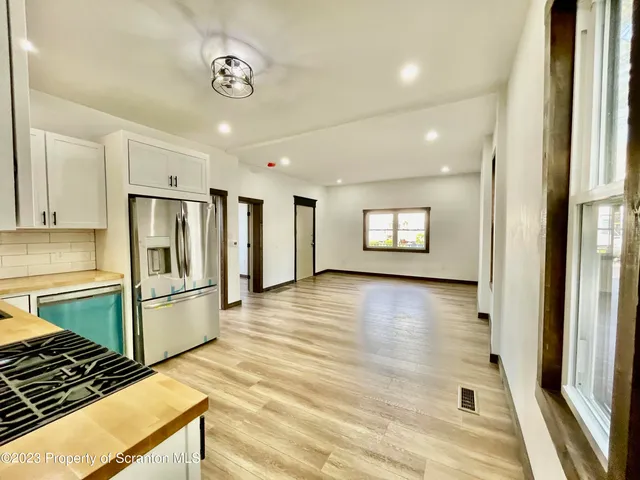 a view of a kitchen with a sink and a refrigerator