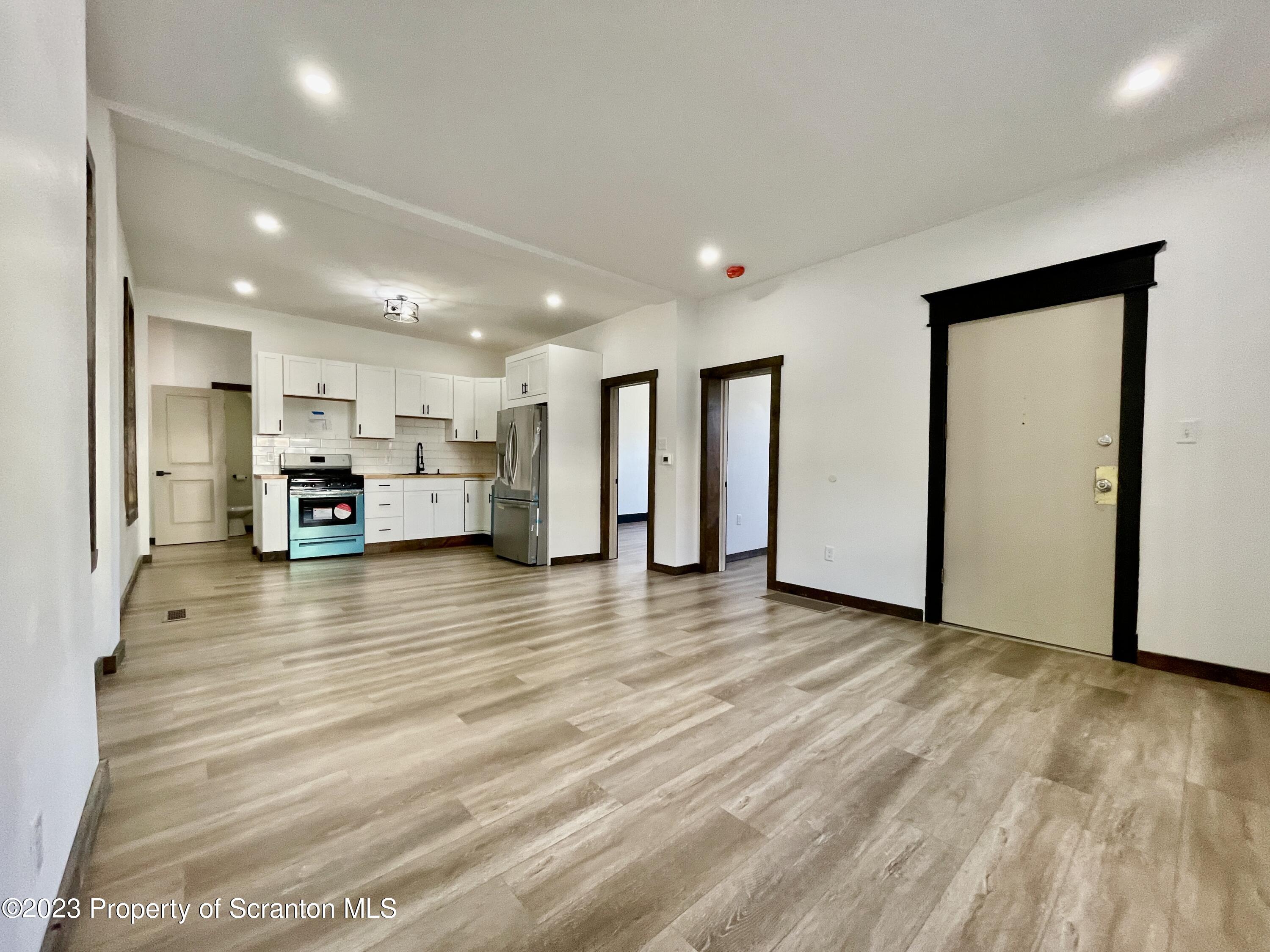 1216 Marion Street Scranton, PA 18509 - Photo 15 of 37 a view of kitchen and kitchen with stainless steel appliances granite countertop wooden floor