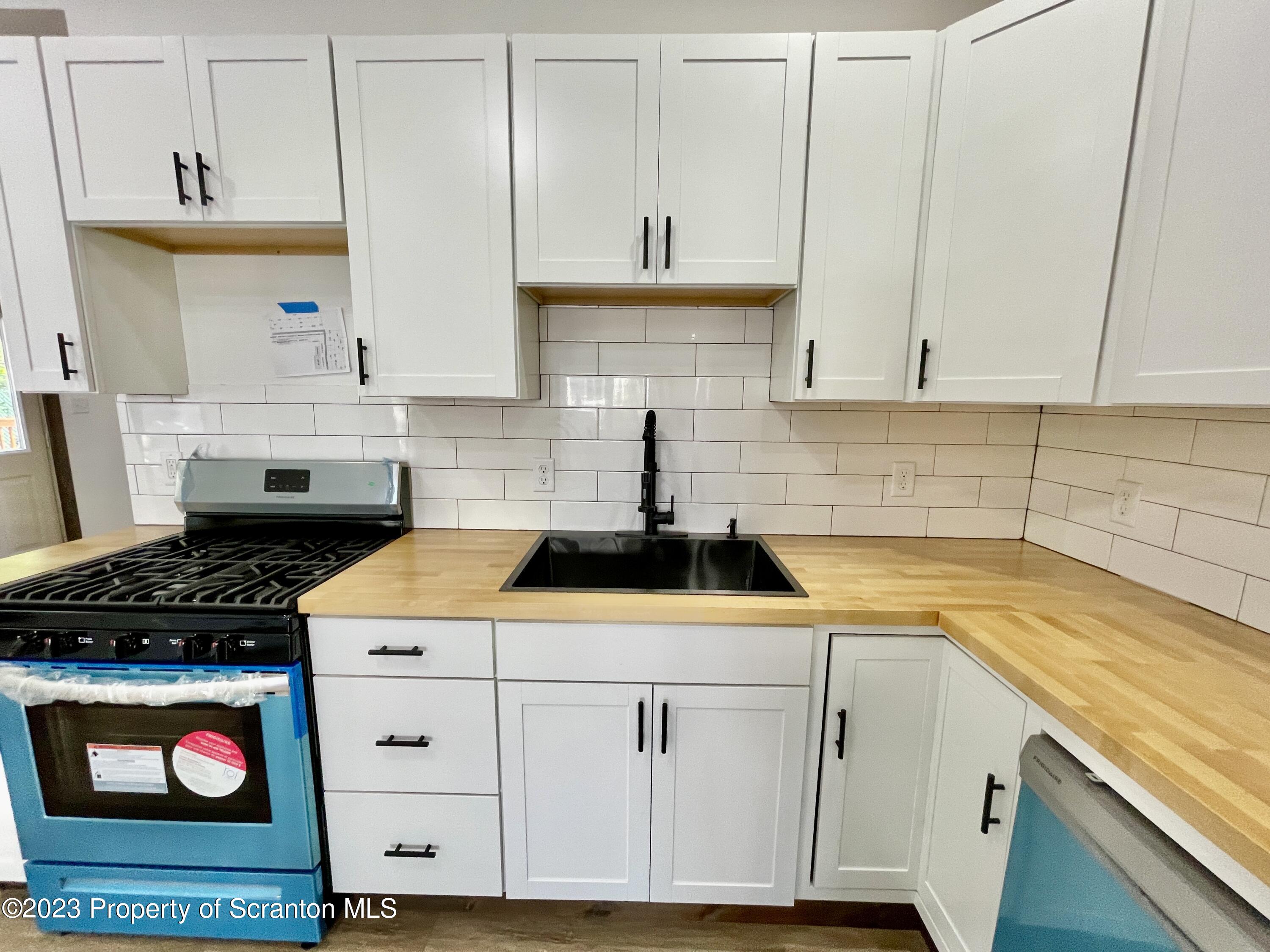 1216 Marion Street Scranton, PA 18509 - Photo 17 of 37 a kitchen with stainless steel appliances granite countertop a sink stove and cabinets
