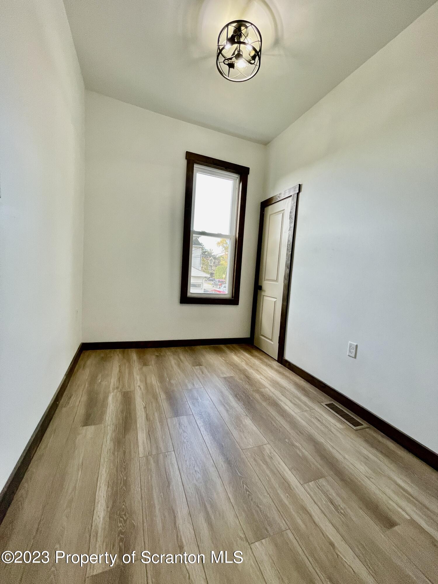 1216 Marion Street Scranton, PA 18509 - Photo 19 of 37 an empty room with wooden floor and windows
