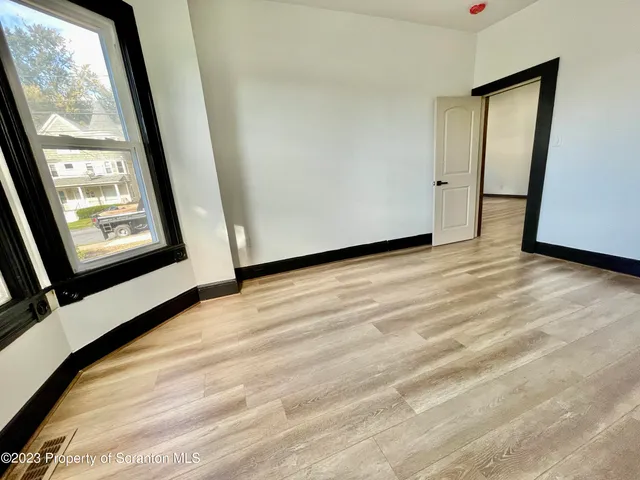 a view of balcony with wooden floor and fence