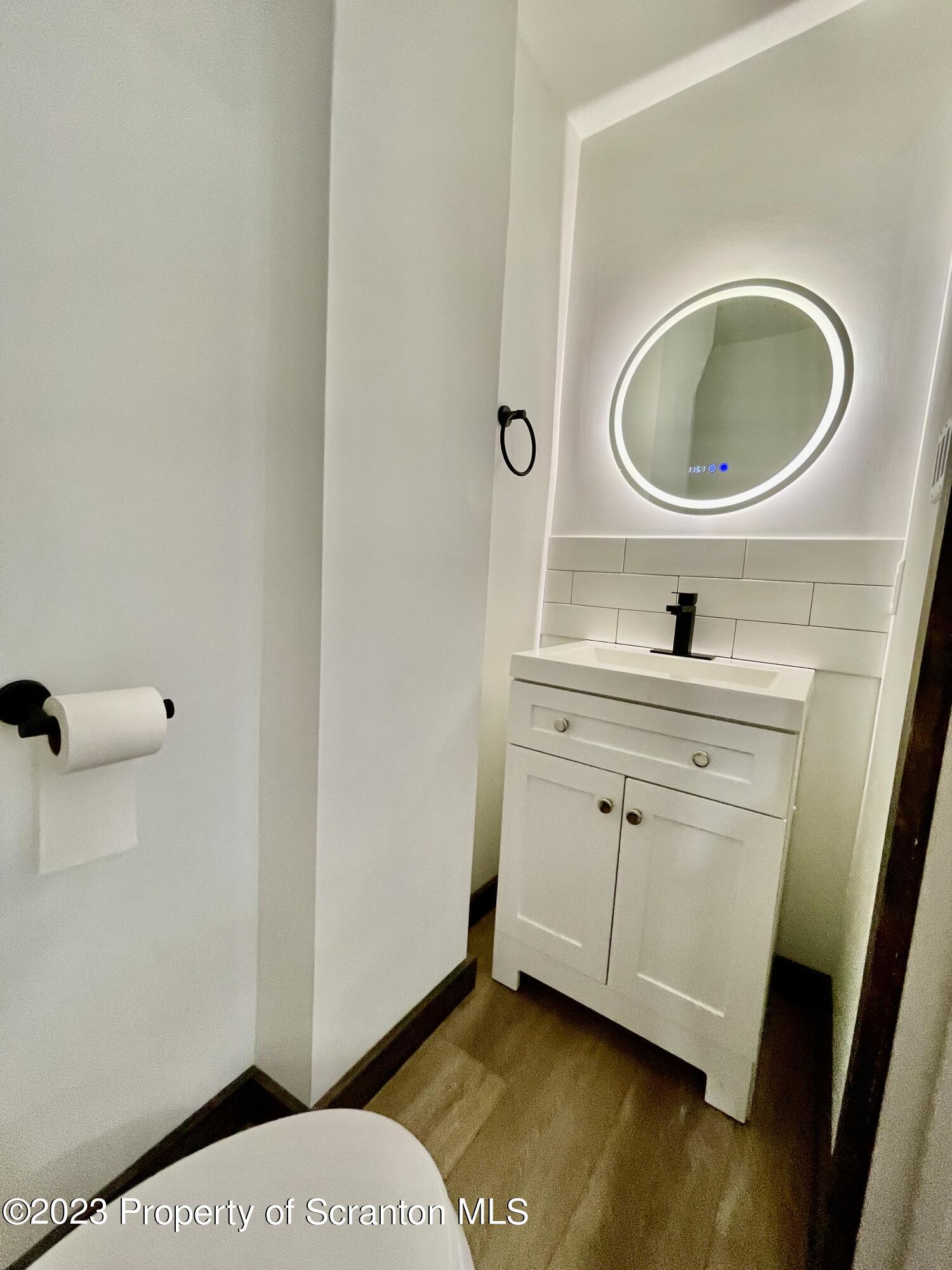 1216 Marion Street Scranton, PA 18509 - Photo 22 of 37 a bathroom with a sink a mirror and a toilet