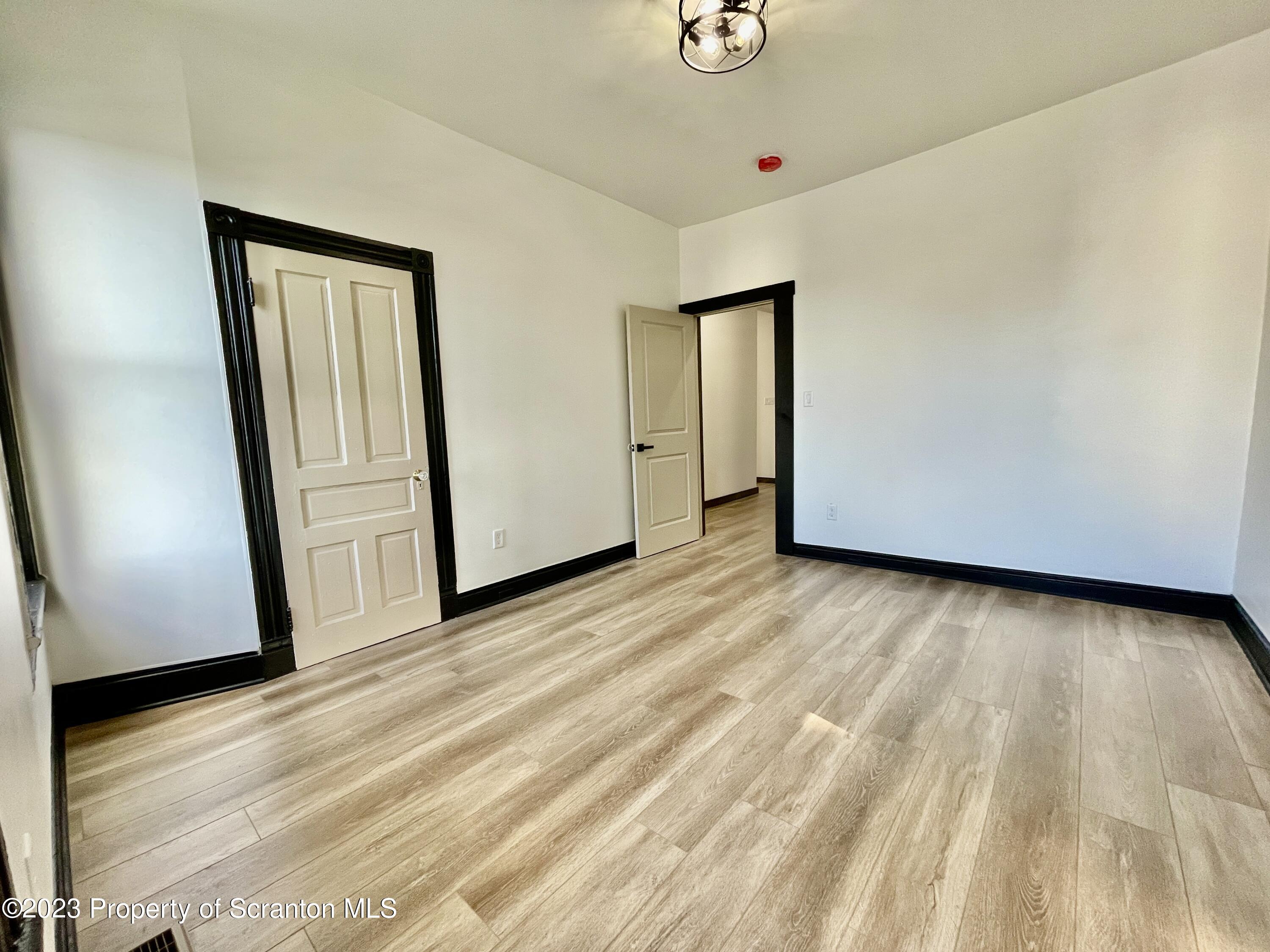 1216 Marion Street Scranton, PA 18509 - Photo 24 of 37 a view of an empty room with wooden floor