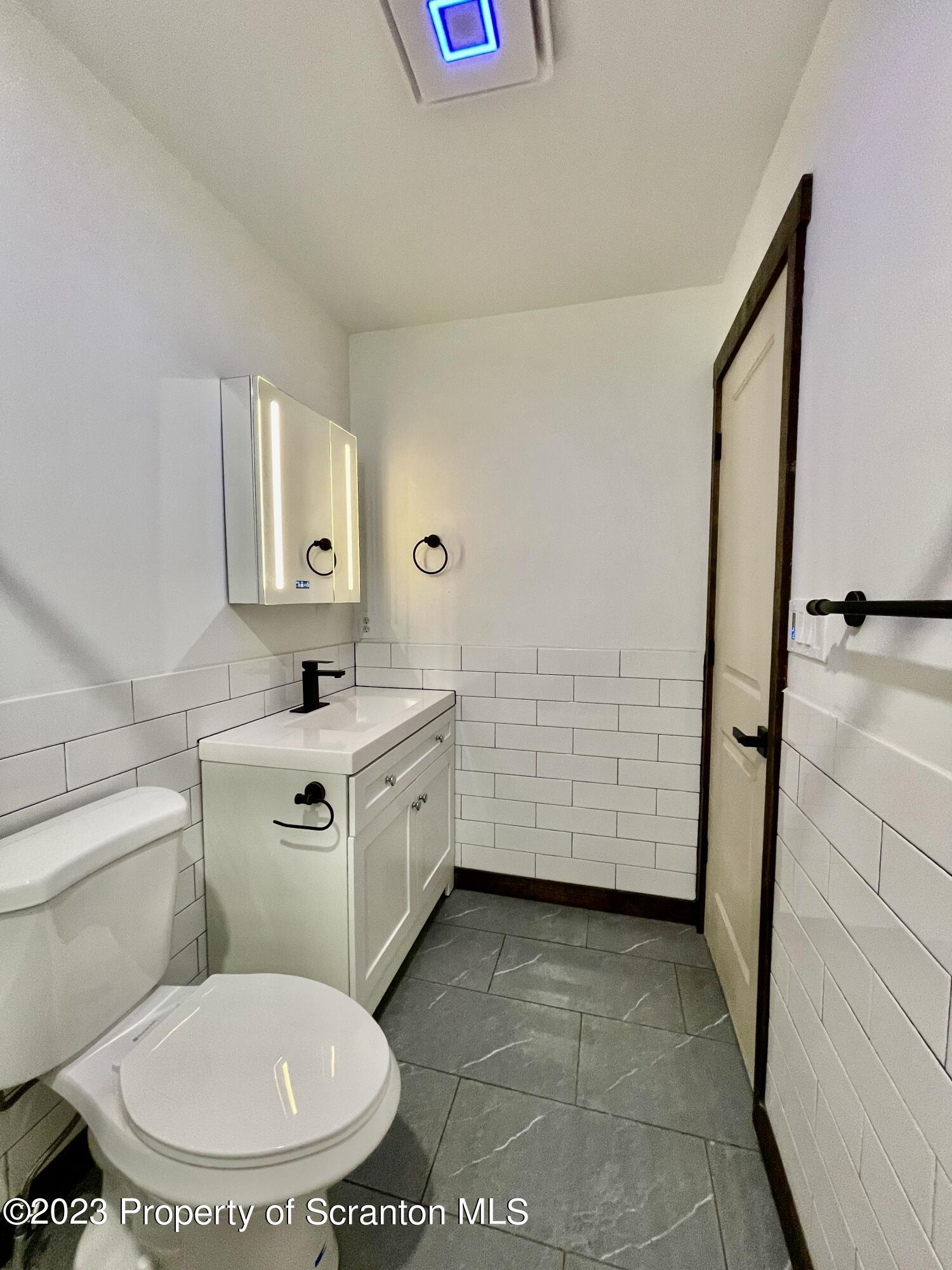 1216 Marion Street Scranton, PA 18509 - Photo 28 of 37 a bathroom with a toilet sink and mirror