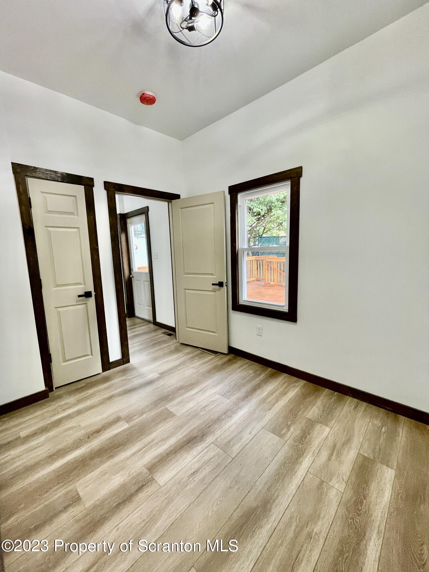 1216 Marion Street Scranton, PA 18509 - Photo 30 of 37 a view of an empty room with window and hardwood floor