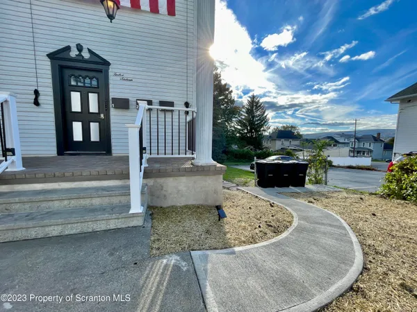 a view of kitchen and kitchen with stainless steel appliances granite countertop wooden floor