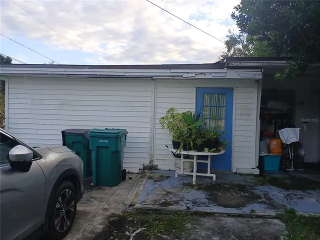 a view of a house with a backyard and a patio