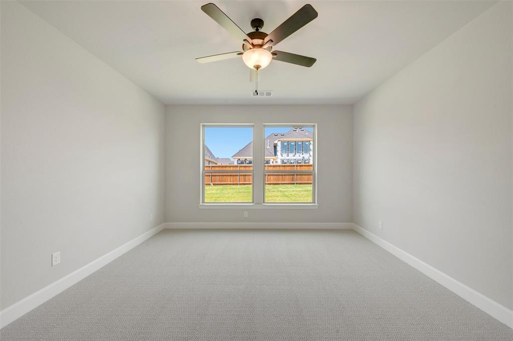 4308 Palomino Road Aubrey, TX 76227 - Photo 26 of 40 an empty room with a window and a ceiling fan