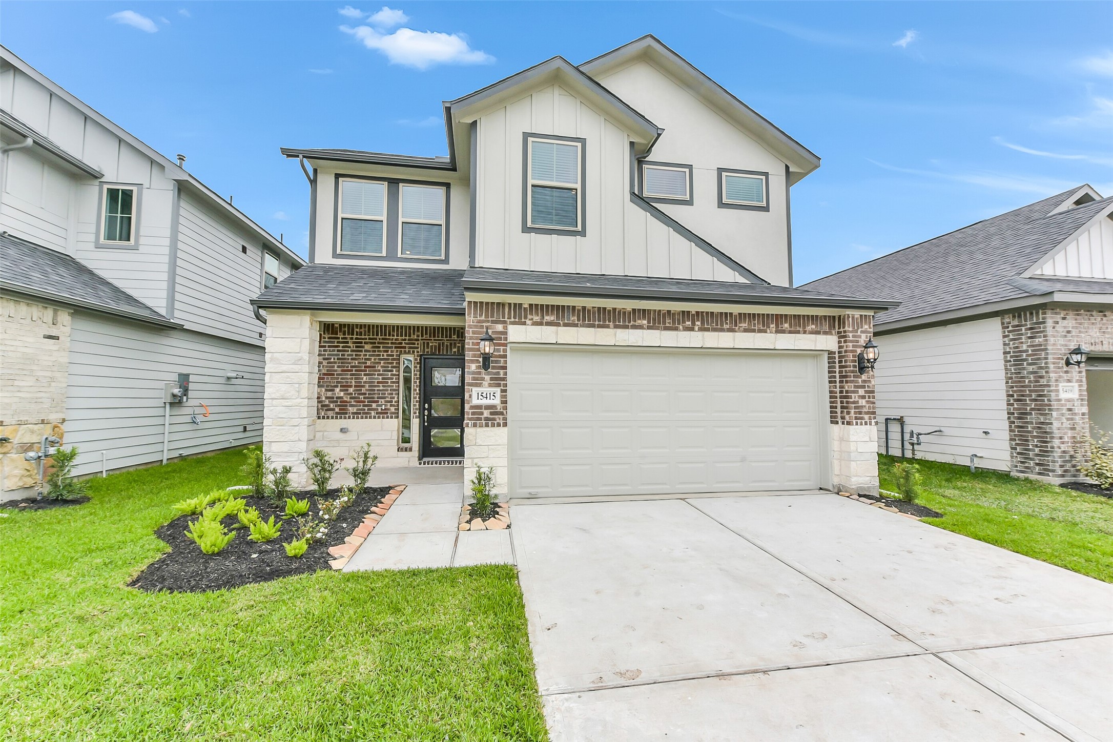 a front view of a house with a yard and garage