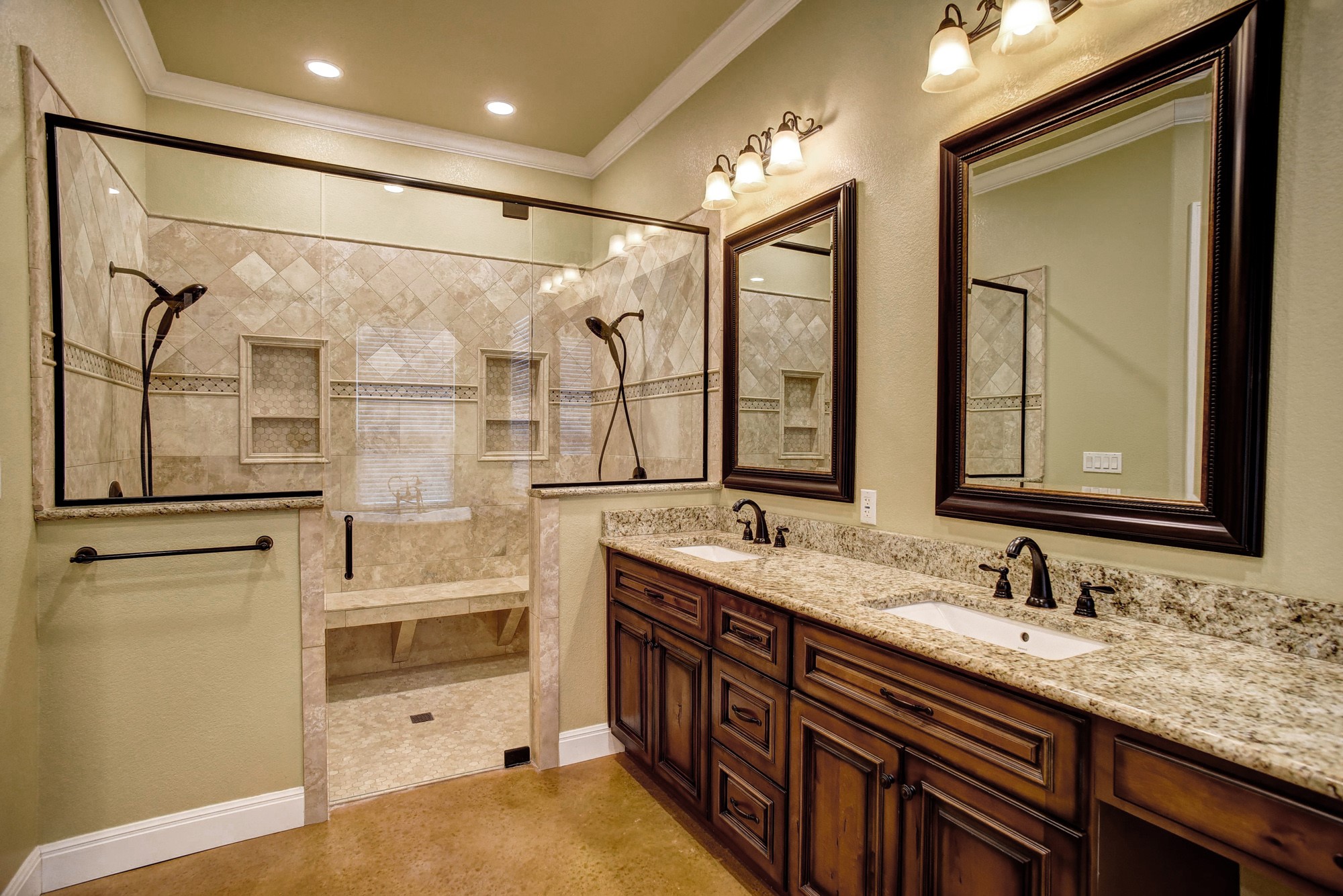 115 Pine Point Cove Elgin, TX 78621 - Photo 18 of 39 Indulge in a primary bathroom featuring a spacious glass shower with bench seating and a double vanity topped with granite counters.