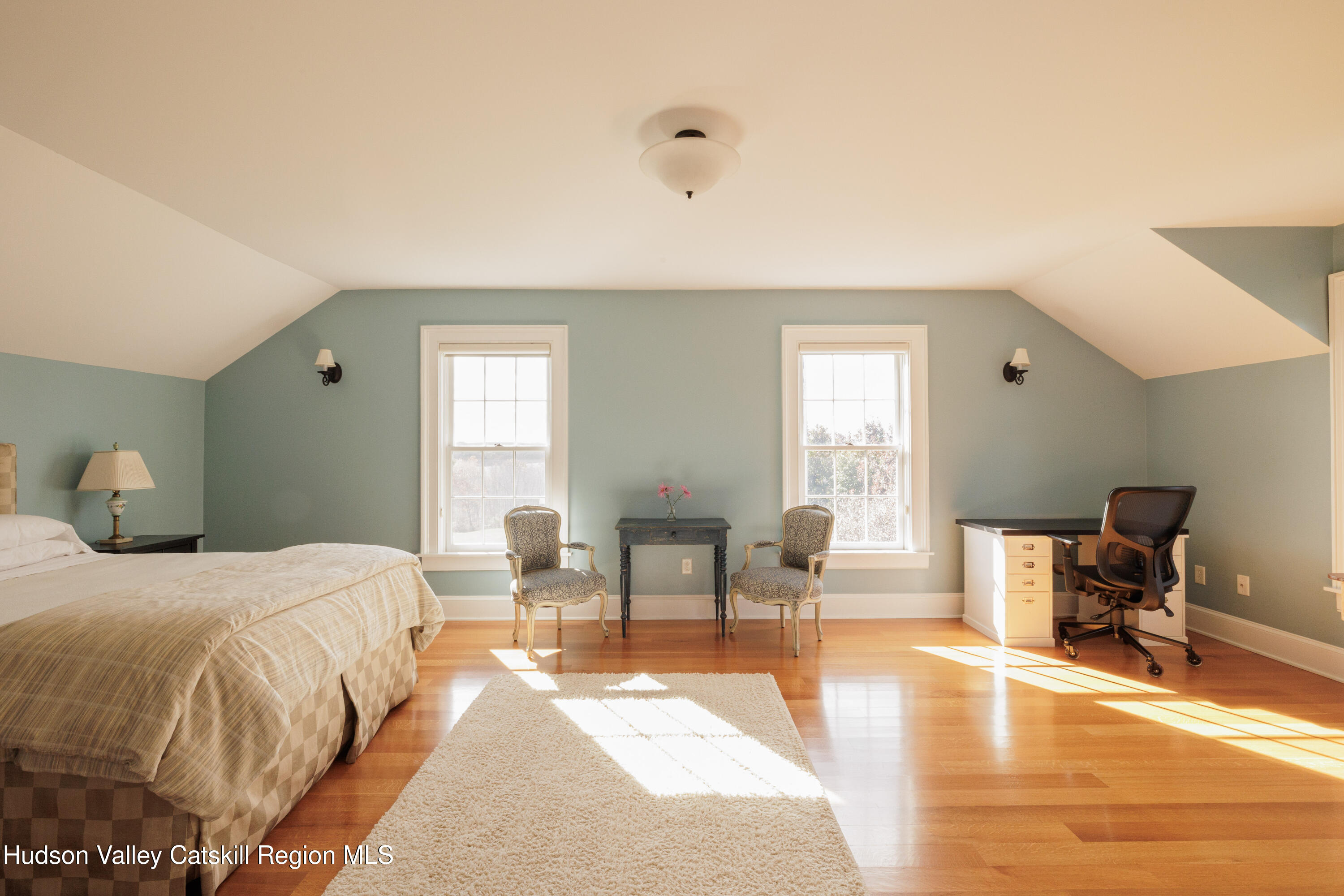 189 Sutherland Road Valatie, NY 12184 - Photo 44 of 94 a spacious bedroom with a bed and wooden floor