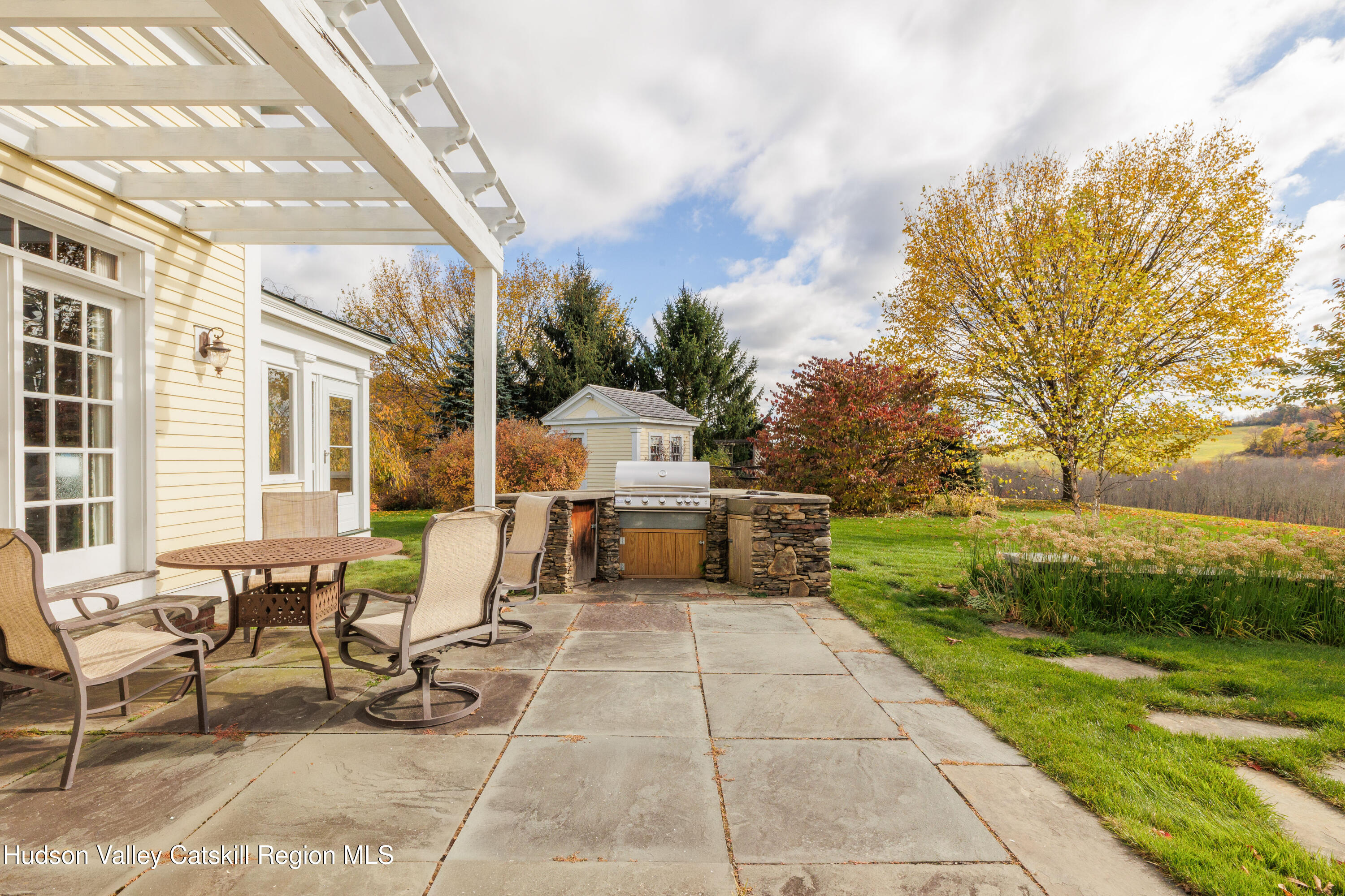 189 Sutherland Road Valatie, NY 12184 - Photo 68 of 94 a view of a patio with dining table and chairs with wooden fence