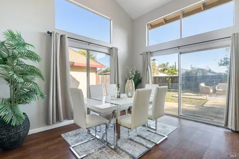 a dining room with furniture wooden floor and a potted plant