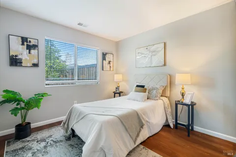a bedroom with a bed and a potted plant