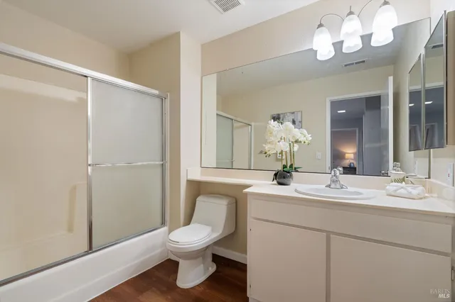 a bathroom with a sink a mirror and a toilet
