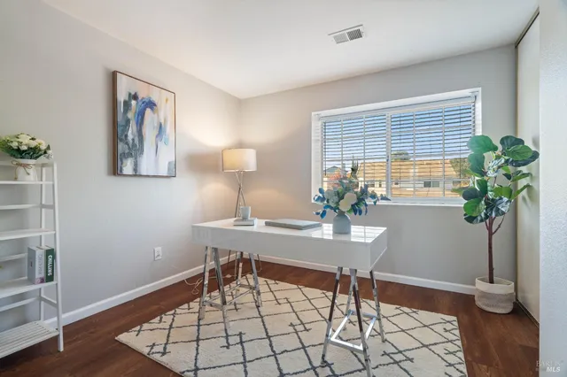 a workspace with furniture and a potted plant