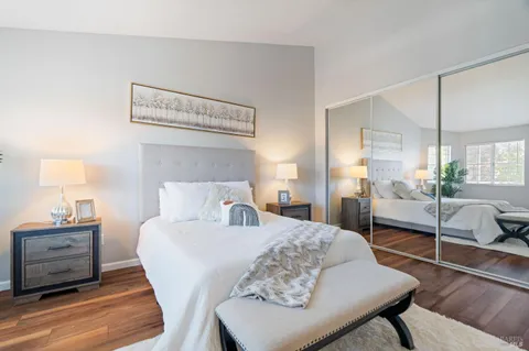 a bedroom with a bed a lamp and a large window