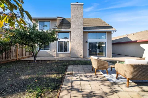 a view of a house with backyard porch and patio