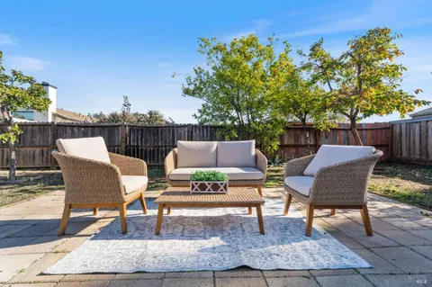 a backyard of a house with table and chairs