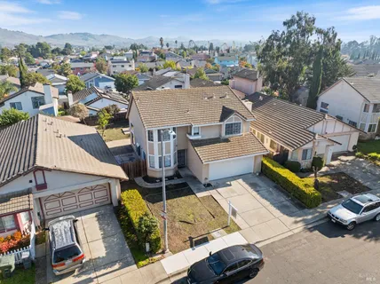 an aerial view of a house with a garden and mountain view