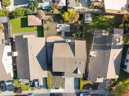 an aerial view of residential houses with outdoor space