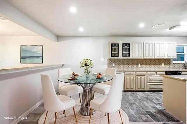 a kitchen with granite countertop white cabinets and stainless steel appliances